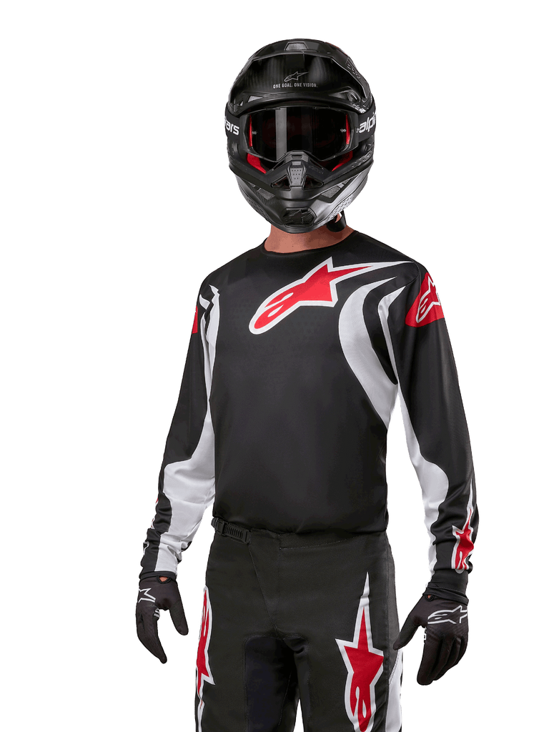 Alpinestars 2024 Fluid Lucent Jersey, Men's Black and White motocross jersey with red logos, worn by a rider with a helmet.