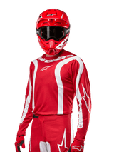 2024 Fluid Lurv Jersey, Motocross Racing Jersey, Mars Red and White, worn with matching red helmet and gloves, bold sporty design with white curved stripes and Alpinestars branding