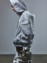Alpinestars RSRV GP Hoodie, Gray, casual motorsport-inspired streetwear with star logo on sleeve, worn with hood up, premium cotton construction, part of RSRV luxury collection