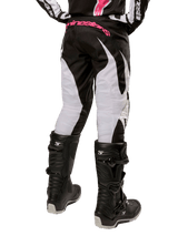 Alpinestars Women Stella 2024 Fluid Pant, Motocross Pants, Black and White, back view showing white leg panels and pink branding on waistband, worn with black Tech 3 boots, durable gear for off-road racing