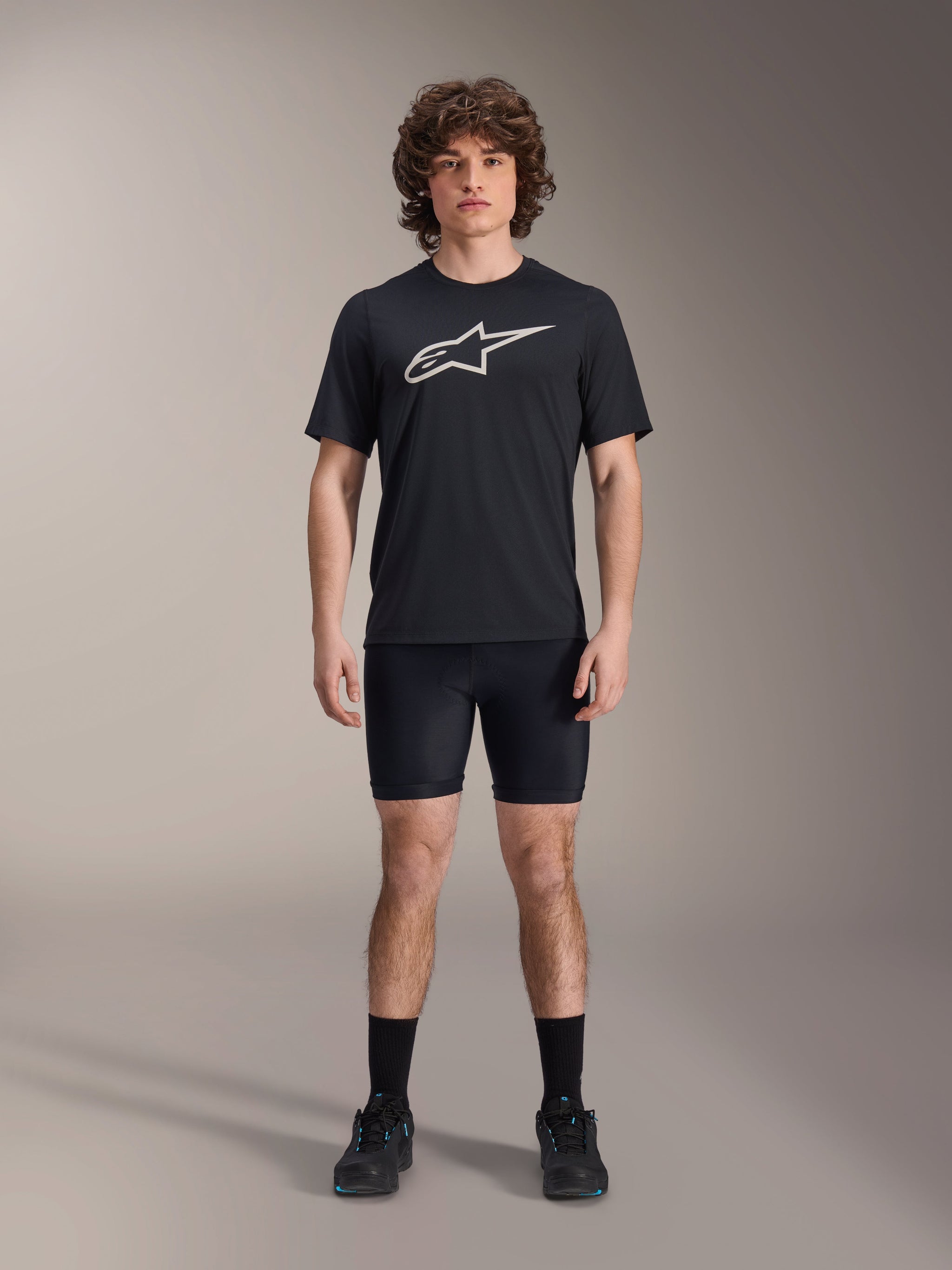 Alpinestars A-Dura Liner Shorts, Black cycling liner shorts, worn by a model with a black Alpinestars logo t-shirt and black cycling shoes, tight-fitting design for MTB performance and in-saddle comfort.