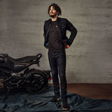 Alpinestars X Diesel AS-DSL Toru Tech Riding Pants Slim Fit, Black Washed Men's Urban Motorcycle Pants shown with a bike.
