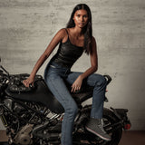 Alpinestars X Diesel AS-DSL Junko Tech Riding Pants, Women's Slim Fit Urban Jeans, Mid Blue denim, seated on motorcycle.