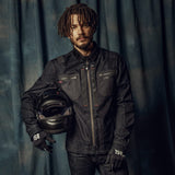 Alpinestars X Diesel AS-DSL Toshio Denim Overshirt, Rinse Blue/Black urban motorcycle jacket, man holding a black helmet.